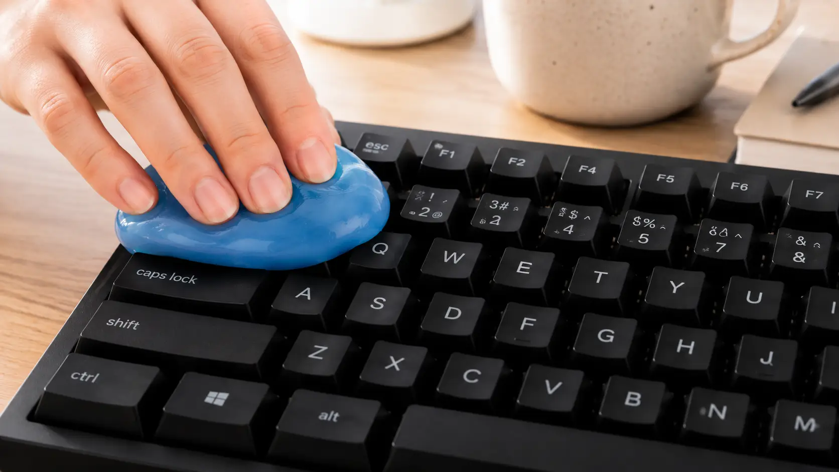 blue keyboard cleaning gel removing dust and crumbs from mechanical keyboard keys, an AI-generated concept 