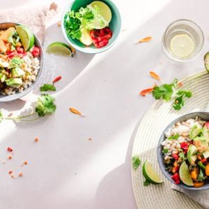 Top-down view of vibrant vegan bowls filled with fresh vegetables, perfect for a healthy meal.